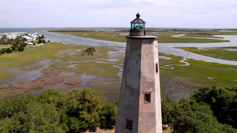 aerial-of-old-baldy,-bald-head-island-lighthouse-on-bald-head-island-nc,-north-carolina-with-marsh-in-background