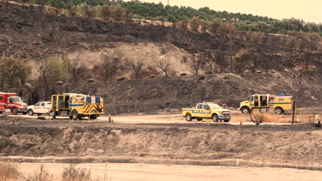 A-distant-shot-of-Fire-Engines-and-Emergency-vehicles-parked-on-the-side-of-a-mountain-to-regroup-and-co-ordinate-their-firefighting-approach-to-the-Fairview-Wildfire,-Hemet,-California