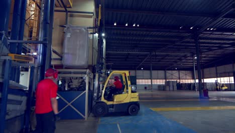 Using-a-forklift-to-lift-a-bag-of-freshly-harvested-coffee-beans-on-the-the-gravity-separator-machine-at-the-factory