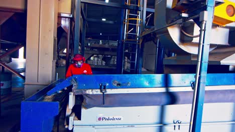 A-worker-checking-the-coffee-bean-gravity-separator-at-the-factory