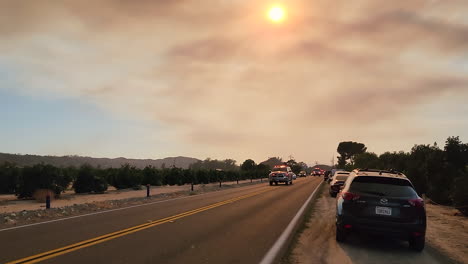 fire-trucks-passing-on-the-highway-near-the-blazing-wildfires-near-Hemet-in-California's-Riverside-County,-killing-two-people