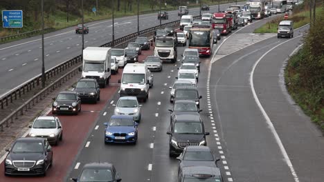 Busy-build-up-of-heavy,-slow-moving-morning-rush-hour-traffic-on-the-M4-motorway,-near-Heston-Services