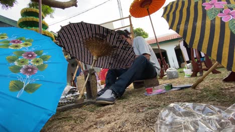 Artista-De-Pintura-De-Paraguas,-Que-Está-Pintando-Su-Trabajo-En-El-Festival-De-Paraguas-De-Indonesia