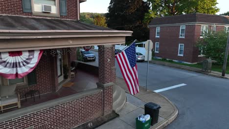 American-home-with-flags,-waste-trash-and-recycling-on-curb