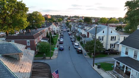 Boy-rides-bike-on-street-in-American-town