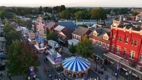 Golden-hour-light-and-long-shadows-on-Victorian-buildings-during-American-street-fair-carnival