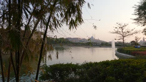 People-walking-in-a-landscaped-garden-Al-Azhar-Park-in-Cairo,-Egypt