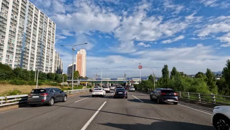 Driver's-pov-driving-on-Gangbyeonbuk-ro-expressway-in-Seoul-city-and-KTX-Train-traveling-on-Hangang-Railway-Bridge-to-Yongsan-Station