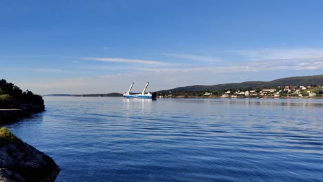 Norways-largest-sailing-vessel-SC-Connector-with-two-massive-rotor-sails-on-deck---Static-clip-of-ship-while-passing-Leroyosen-south-of-Bergen-Norway---Rotor-sails-on-deck-to-save-fuel