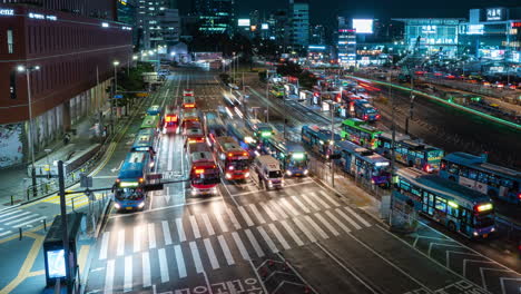 Lapso-De-Tiempo-De-Tráfico-Nocturno-De-La-Estación-De-Seúl---Muchos-Autobuses-Y-Automóviles-Se-Detienen-En-Los-Semáforos-En-Carreteras-Concurridas---Vista-Superior-De-Gran-Angular