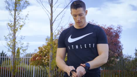 Slowmotion-shot-of-an-athletic-man-putting-on-gymnastic-hand-grips