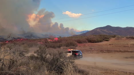 A-police-car-speeding-toward-a-wildfire-site