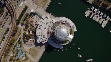 Aerial-view-above-the-Science-World,-in-sunny-Vancouver,-Canada---top-down,-drone-shot