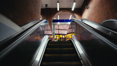 Passenger-point-of-view-riding-escalator-into-London-Waterloo-station