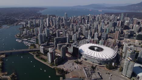 BC-Place-Stadium-and-the-Yaletown-skyline,-sunny,-fall-day-in-Vancouver---Aerial-view