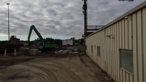 POV:-Trucker-driving-slowly-next-to-the-building-on-the-construction-site-towards-the-crane