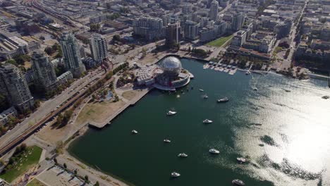 Aerial-view-approaching-the-Science-World,-in-sunny-Vancouver,-Canada---tilt,-drone-shot