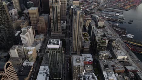 Aerial-view-overlooking-seaside-skyscrapers-in-downtown-Seattle,-during-sunset---circling,-drone-shot