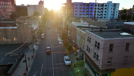 Harsh-rising-sun-shining-through-city-buildings