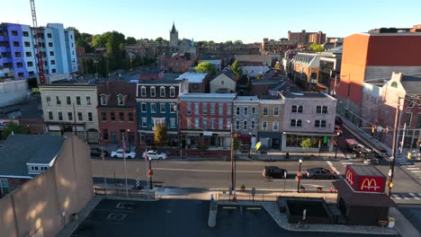 Aerial-establishing-shot-of-an-American-city-street-on-a-sunny-day