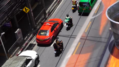 Overlooking-From-Rooftop-Bar-At-Traffic-Going-Past-In-Bangkok