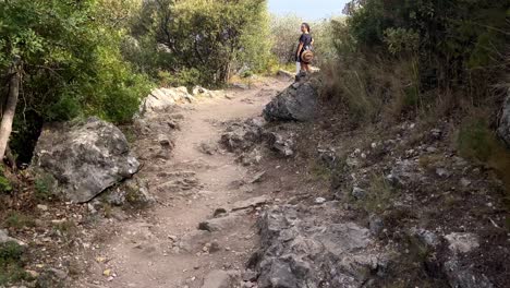 Rugged-Landscape-In-Nietzsche-Path,-Woman-Standing-In-Distance,-In-Eze,-France---tilt-up