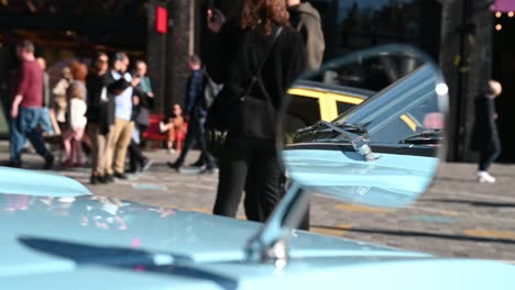 Looking-through-the-mirror,-Classic-Car-Boot-Sale,-Coal-Drops-Yard,-London,-United-Kingdom