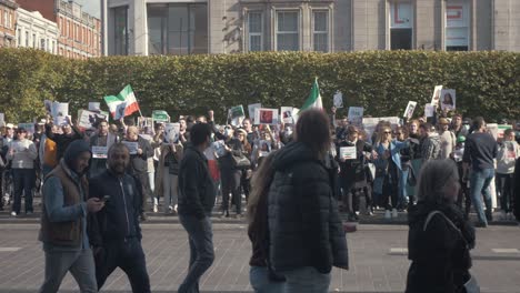 Protest-against-the-oppressive-Iranian-Regime-after-the-death-of-Mahsa-Amini,-passerbys-in-foreground