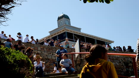 Slider-shot-of-spectators-whale-watching-in-Hermanus,-South-Africa