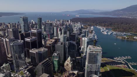 Skyscrapers-in-Coal-Harbour,-sunny-Vancouver-city,-daytime-in-BC,-Canada---Aerial-view