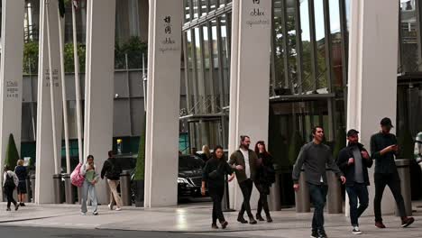 People-Walking-Past-The-Entrance-To-The-Shard,-Aqua,-Ablix,-Ting,-London,-United-Kingdom