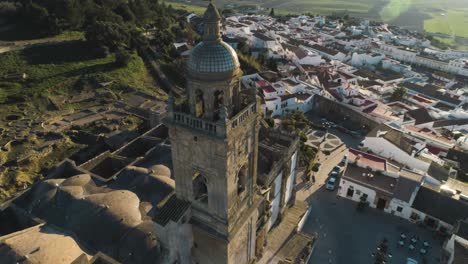 Aerial-rotating-shot-of-the-church-in-santa-maria-in-the-wonderful-old-town-medina-sidonia-in-the-province-of-cadiz-in-spain-with-white-buildings-and-view-of-the-landscape