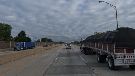 POV-truck-driving-really-slow-on-a-road-while-other-cars-and-trucks-move-past-them-in-Indiana,-Gary,-USA