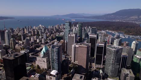 Aerial-view-around-skyscrapers-in-the-Financial-District-of-Vancouver,-sunny,-fall-day-in-BC,-Canada---circling,-drone-shot