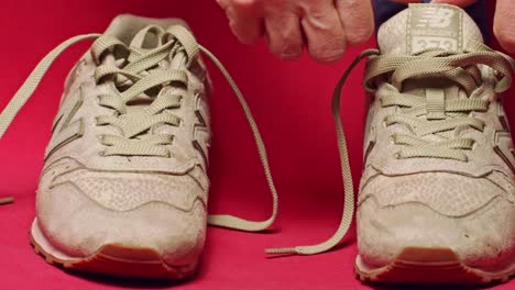 Person-wearing-New-Balance-casual-streetwear-shoes-in-studio-with-red-background