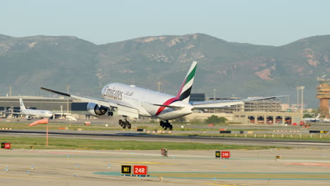 Avión-Comercial-De-Emiratos-Aterrizando-En-El-Aeropuerto-De-Barcelona,-Tiro-De-Seguimiento,-Día