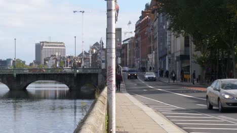 Vehículos-Circulando-Por-La-Calle-Merchant&#39;s-Quay-En-El-Banco-Del-Río-Liffey-En-Dublín,-Irlanda