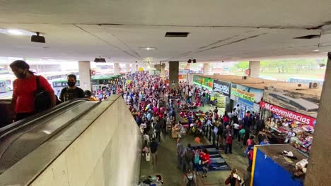 Commuters-walking-around-busy-bus-terminal-station-in-Brasilia,-Brazil