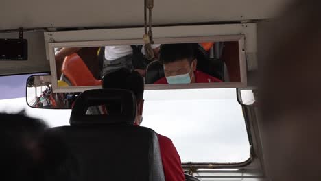 Transportation-boat-driver-working-and-steering-the-boat-on-the-Chao-Phraya-River-in-Bangkok,-Thailand