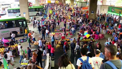 Crowd-of-commuters-and-travelers-walking-at-a-bus-terminal-station-in-Brasilia,-Brazil