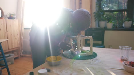 4k-60fps---An-african-american-artist-sculpting-a-clay-box-in-her-studio-during-golden-hour