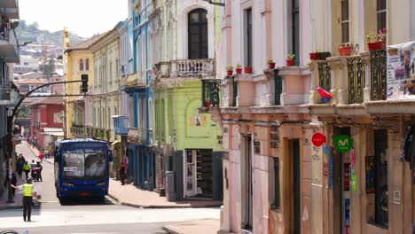 Colorful-Colonial-Houses,-Bus-passing-through-Traditional-Streets-Quito-Ecuador-City-Center