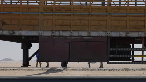 A-Dakar-Rally-helicopter-waiting-for-take-off-with-multiple-vehicles-passing