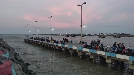 people-enjoying-the-dramatic-twilight-sky-over-the-beach