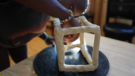 4k-60fps---An-african-american-artist-sculpting-a-box-in-her-studio-during-golden-hour