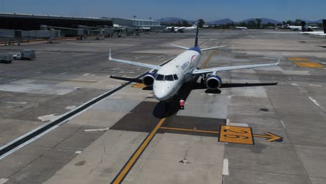 Aerial-view-around-a-plane-at-a-aerodrome-in-Mexico-city---circling,-drone-shot