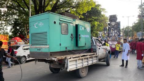 Video-of-the-small-lorry-carrying-generator-which-is-generating-electricity-for-the-float-moving-forward-and-carrying-idol-of-Goddess-Durga-Maa