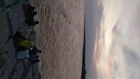 People-enjoy-the-dramatic-twilight-sky-over-the-beach