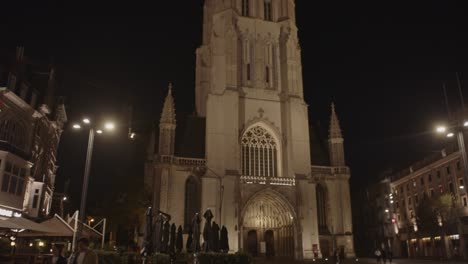 Tilt-up-of-beautiful-cathedral-tower-in-Ghent,-Belgium-at-night