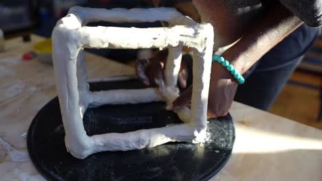 4k-60fps---An-african-american-artist-sculpting-a-clay-box-in-her-studio-during-golden-hour